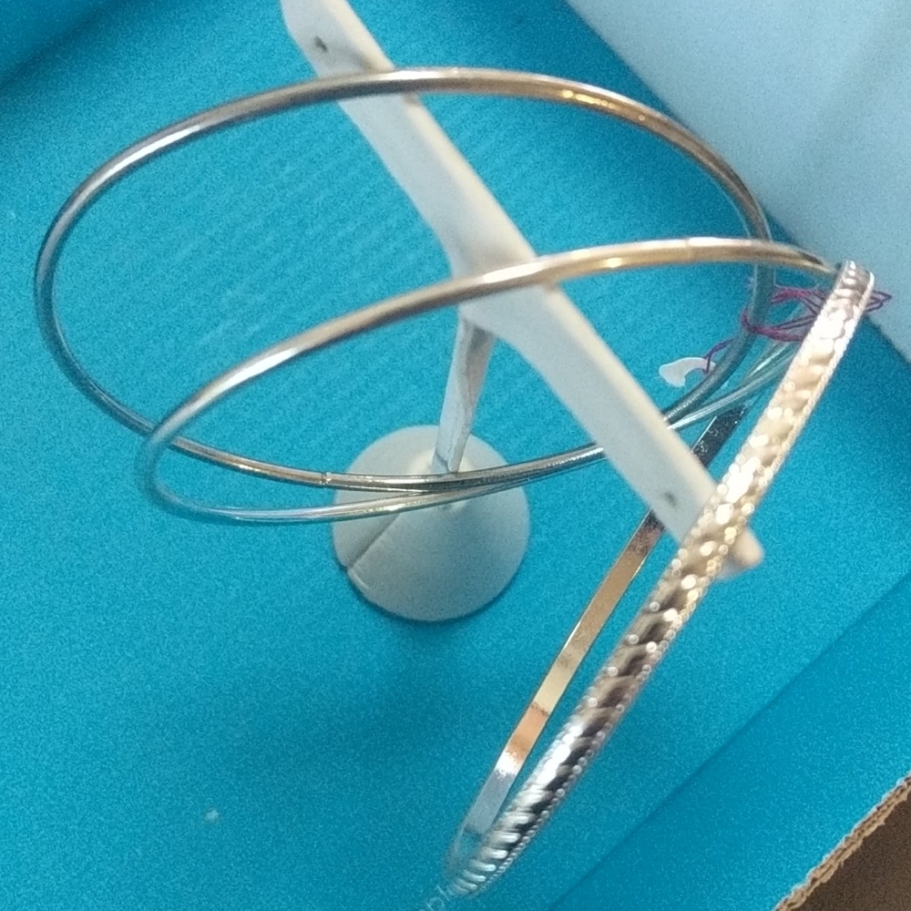 Three silver bracelets